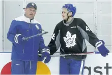  ?? JACK BOLAND/TORONTO SUN FILES ?? Maple Leafs assistant coach D.J. Smith speaks with rookie Timothy Liljegren at Toronto’s developmen­t camp in July. Smith is likely to get a shot at being a head coach somewhere in the NHL, but Mike Babcock has advised him to take a little more time...