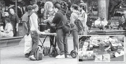  ?? ?? MAKING GREEN: Business is brisk in Washington Square Park Monday, where a variety of still-illegal pot parapherna­lia is openly available for purchase.