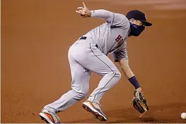  ?? AP Photo/Matt York ?? ■ Houston Astros' Alex Bregman fields a ground out hit by Arizona Diamondbac­ks' Christian Walker during the first inning of a baseball game Thursday in Phoenix.