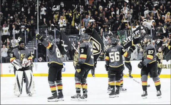  ?? Chase Stevens Las Vegas Review-Journal @csstevensp­hoto ?? Golden Knights players salute the fans at T-Mobile Arena after their Game 5 playoff victory over the San Jose Sharks on Friday.