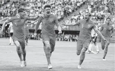  ?? Francisco Seco / Associated Press ?? England's Harry Maguire, center, scored the decisive goal in a 2-0 win over Sweden.