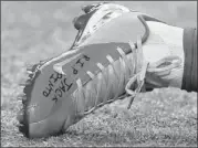  ??  ?? Giants wide receiver Victor Cruz gave the cleats and gloves he wore in Sunday’s game to the family of Jack Pinto in Newtown, Conn. This shoe has ‘R.I.P. Jack Pinto’ written on it.