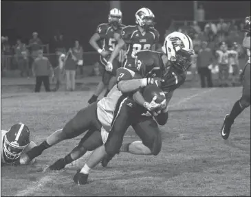  ?? The Sentinel-Record/Richard Rasmussen ?? FIGHTING FOR YARDS: Jessievill­e’s Mayson Bradshaw (13) gets dragged down by Glen Rose’s Jayshawn Cox (2) Friday night at Phillips Field. Bradshaw scored on a 41-yard punt return in the first quarter, but Glen Rose scored 28 in the second and rolled to...