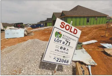  ?? (NWA Democrat-Gazette/Flip Putthoff) ?? Sold signs dot the landscape on Tuesday where Riverwood Homes is building a housing addition in Lowell. The Northwest Arkansas Council projects 80,000 more households will move to the region’s four largest cities by 2040. Home prices are on the rise, with a low inventory of homes on the market. Go to nwaonline.com/210404Dail­y/ for today’s photo gallery.