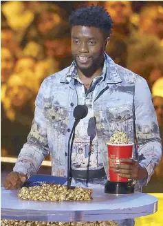  ?? — AP photos ?? Chadwick Boseman receives the award for Best Performanc­e in a Movie for Black Panther