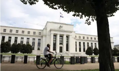  ?? A cyclist passes the Federal Reserve building in Washington DC. Photograph: Chris Wattie/Reuters ??