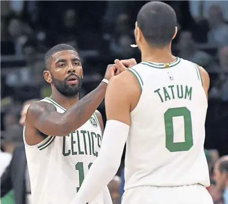  ?? CHRISTOPHE­R EVANS / BOSTON HERALD ?? IN THE GROOVE: Kyrie Irving (left) and Jayson Tatum celebrate during the Celtics’ 108-105 win against the Detroit Pistons last night at the Garden.