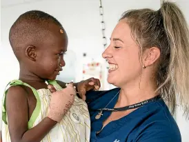  ??  ?? Lauren with Ablaye, her hand therapy patient who received free reconstruc­tive surgery on his burned hand on the Mercy Ship.