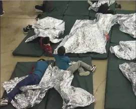  ?? U.S. CUSTOMS AND BORDER PROTECTION’S RIO GRANDE VALLEY SECTOR VIA AP ?? In this photo provided by U.S. Customs and Border Protection, people who’ve been taken into custody related to cases of illegal entry into the United States, rest in one of the cages at a facility in McAllen, Texas, on Sunday.