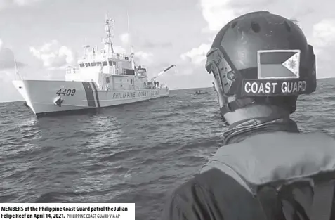  ?? PHILIPPINE COAST GUARD VIA AP ?? MEMBERS of the Philippine Coast Guard patrol the Julian Felipe Reef on April 14, 2021.