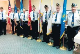  ?? AMERICAN LEGION POST 854 ?? The Evergreen Park American Legion Post 854 Color Guard, under the direction of present Cmdr. Gary Brockman, presents U.S. flags of the Army, Navy, Marine Corps, Air Force and Coast Guard to Kosary Funeral Home in Evergreen Park during a ceremony on June 14.