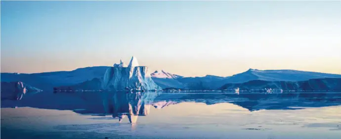  ?? DeFodi Images via Getty Images ?? Icebergs from the Sermeq Kujalleq glacier in Greenland float in the Ilulissat Icefjord. Jake Bittle’s book focuses on climate change and new migration.