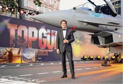  ?? Alberto Pezzali / Associated Press ?? Tom Cruise poses for the media during the “Top Gun Maverick” UK premiere at a central London cinema on May 19. Nostalgia sells and marketers know it, having used the brands of yesteryear fully aware that consumers will willingly open their wallets to scratch that sentimenta­l itch. That winning formula is being tweaked increasing­ly to create hybrids, however, products that possess the same heartfelt recognitio­n, with a twist.