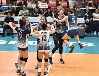  ??  ?? THE NU LADY BULLDOGS celebrate a point during their three-set win over the UE Lady Warriors on April 8 that stopped their five-game losing streak.