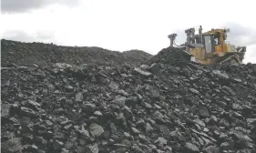  ?? TROY FLEECE FILES ?? A bulldozer pushes coal toward the Boundary Dam Power Station near Estevan. People in the southeast are worried about the move away from coal, Murray Mandryk says.