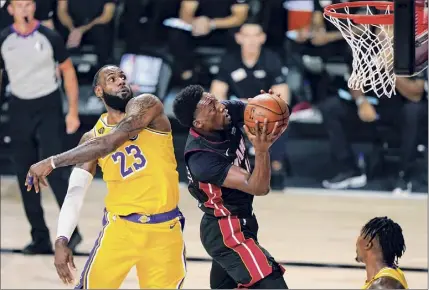  ?? Mark J. Terrill / AP ?? Miami’s Bam Adebayo drives past Los Angeles' Lebron James in the first half of Game 1 of the NBA Finals on Wednesday. The game ended too late for this edition. For a story, go to http://timesunion.com.