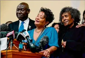  ?? Matt Rourke / Associated Press ?? The daughters of Ruth Whitfield, a victim of a shooting in Buffalo, Angela Crawley, center, and Robin Harris, with attorney Benjamin Crump Monday.