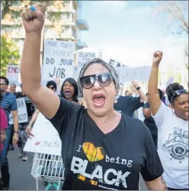  ?? Josh Edelson AFP/Getty Images ?? PROTESTERS show support for Stephon Clark on the day of his funeral. Sacramento police silenced their body cameras as they regrouped after killing him.