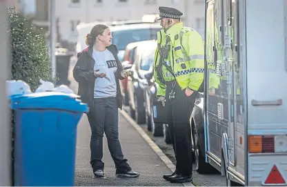  ?? Pictures: Mhairi Edwards. ?? A police officer chats to a resident on Alison Street, near the murder house.