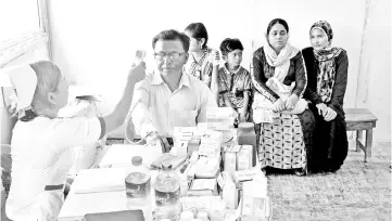  ?? — AFP photo ?? A Rohingya family undergoes health screening before they received their identifica­tion documents at Taungpyole­twei town repatriati­on camp in Maungdaw near Bangladesh border.