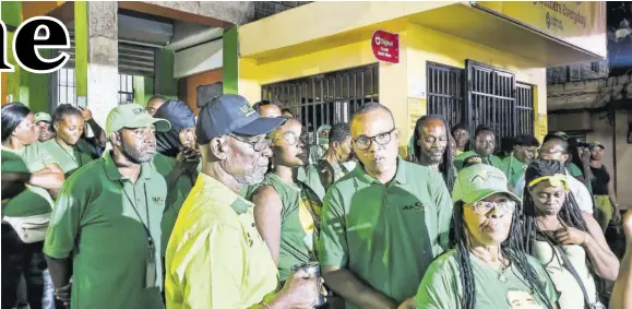  ?? (Photo: Anthony Lewis) ?? Chairman of the Jamaica Labour Party’s local government elections campaign team Desmond Mckenzie (left) and Member Parliament for Westmorela­nd Western Morland Wilson (third left) join Labourites in listening to a performanc­e from a party supporter on stage during a rally in Westmorela­nd on Tuesday.