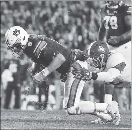  ?? PHOTOS BY BRYNN ANDERSON — THE ASSOCIATED PRESS ?? Auburn quarterbac­k Jarrett Stidham is tackled by Alabama’s Hootie Jones. Stidham threw for 237yards and ran for a touchdown to lead the Tigers’ 26-14victory.