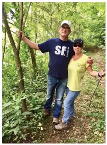  ??  ?? Dr. Quigley hiking with his wife, Renee