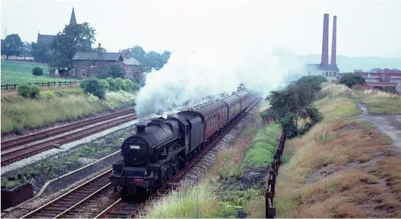  ?? R N Smith Collection ?? The summer 1963 timetable saw the long-establishe­d Bradford to Poole service gain through coaches from Leeds. Stanier ‘Jubilee’ class 4-6-0 No 45562 Alberta passes the closed station at Bradley Junction on the approach to Huddersfie­ld with the Leeds section in the summer of 1966. This left Leeds at 09.08 and within minutes of it passing here the main train from Bradford, often hauled by a Fairburn ‘4MT’ 2-6-4T, will have appeared on the left hand lines, having left two minutes earlier, at 09.06. The two trains combined at Huddersfie­ld and the ‘Jubilee’ then took it via Penistone, Barnsley and the MR lines to Nottingham (Midland), where it reversed. A diesel from Leicester depot then worked the train onwards, which ran as train 1O43, the 09.06 Bradford (Exchange) to Poole, via the Midland main line to London, and on to the Southern. The train had previously used the GC main line until the end of the summer 1964 timetable, and then in the 1965 season a route that included the Varsity Line to regain the original route at Oxford.