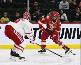  ?? ANDY CROSS — THE DENVER POST ?? Denver forward Tristan Broz shoots against Boston University defenseman Cade Webber in the second period of Thursday’s Frozen Four semifinal at Xcel Energy Center in St. Paul, Minn.