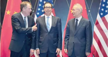  ?? — Reuters ?? US Trade Representa­tive Robert Lighthizer gestures towards Treasury Secretary Steven Mnuchin as he chats with Chinese Vice Premier Liu He before they pose for a family photo at the Xijiao Conference Center in Shanghai, China.