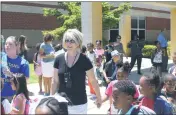  ?? STAFF PHOTOS BY JOHNATHON CLINKSCALE­S ?? Above left, school librarian Dawn Murphy of Hughesvill­e hugs one of her students after being dismissed for summer break. Above right, J.C. Parks Elementary School Vice Principal Robynn Mudd smiles as she helps escort a group of students to waiting buses in the parking lot.