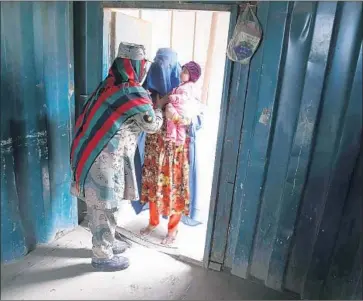  ?? Ghulamulla­h Habibi EPA/Shuttersto­ck ?? AN AFGHAN refugee, with child, is frisked as she crosses into Afghanista­n from Pakistan. An estimated 1.4 million Afghans registered as refugees in Pakistan have been ordered to leave the country by June 30.