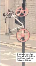  ??  ?? A Mobike hanging from a traffic light at the Royal Northern College of Music