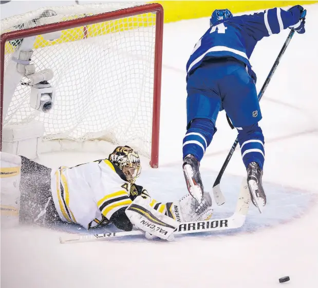  ?? PHOTOS: PETER J THOMPSON / NATIONAL POST ?? Auston Matthews goes airborne as he attempts to put the puck by Boston goalie Tuukka Rask in third-period action Monday night.
