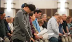  ?? JENNIFER LETT/SUN SENTINEL ?? Members of B’nai Aviv Synagogue in Weston, Fla. pray along with Rabbi Adam Watstein on Sunday. Watstein tells the community, “It may indeed happen again — it’s been happening for 2,000 years.”