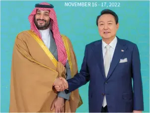  ?? ?? Saudi Arabia’s Crown Prince Mohammed bin Salman shakes hands with South Korea’s President Yoon Suk-yeol as they pose for a photo in Seoul, South Korea, on Thursday. — reuters