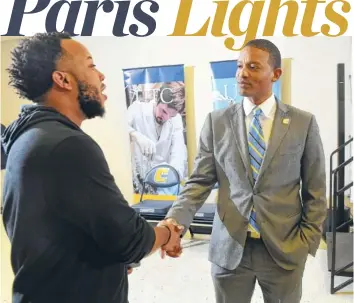  ?? STAFF PHOTOS BY TIM BARBER ?? New UTC men’s basketball coach Lamont Paris, right, meets Steve Cook after a news conference Tuesday.