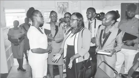  ?? (DPI photo) ?? Minister within the Ministry of Public Health, Dr. Karen Cummings (second from lefty) engages with a staffer of the Health Centre