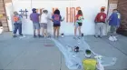  ?? MIKE DE SISTI/MILWAUKEE JOURNAL SENTINEL ?? Carol Winfield, far left, of Pleasant Prairie and her family members paint Kenosha Strong on a building Sunday.