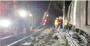  ?? TWU ?? Repair work is done after A-train derailment in Harlem on June 27, 2017, a mishap that ended up costing the MTA $3.4 million.