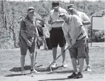  ?? Kathy Johnson ?? It was a scene straight out of the movie Happy Gilmore as golfers tried putting with hockey sticks during the Jody Shelley Golf Fore Health tournament at the River Hills Golf Course in Clyde River.