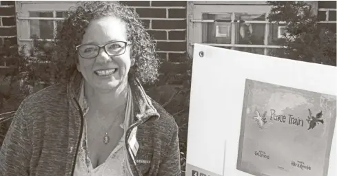  ?? Bill Atwood ?? Christine Morrow led a “Storywalk” of Cat Stevens’ Peace Train Mar. 17. at the library in St. Jacobs.