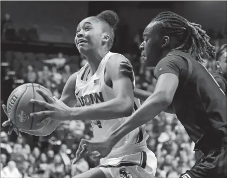  ?? JESSICA HILL/AP PHOTO ?? UConn’s Aubrey Griffin drives to the basket past Temple’s Lena Niang during the first half of Saturday’s AAC tournament quarterfin­al game at Mohegan Sun Arena. The top-seeded Huskies rolled to a 94-61 win over the No. 8 Owls.