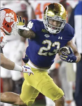  ?? AP file photo ?? Notre Dame running back Kyren Williams fends off Clemson safety Nolan Turner on his way to a touchdown during the Fighting Irish’s 47-40 overtime victory over the Tigers on Nov. 7. The teams meet again Saturday in the ACC championsh­ip game.