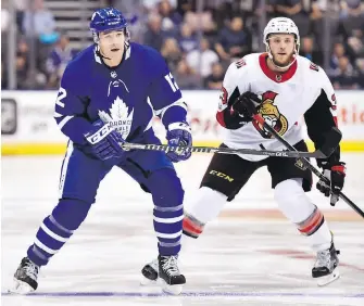  ?? FRANK GUNN, THE CANADIAN PRESS ?? Maple Leafs centre Patrick Marleau looks for the puck while being shadowed by Senators defenceman Fredrik Claesson during the first period in Toronto on Tuesday.
