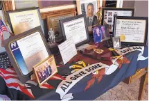  ?? DEAN HANSON/JOURNAL ?? These awards and certificat­es were bestowed on Ralph Rodriguez Jr., 98, a medic who served with the 515th Coast Artillery in Bataan.