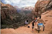  ?? RUTH FREMSON / THE NEW YORK TIMES ?? Visitors view the Canyon Overlook in Zion National Park in southwest Utah. A Trump administra­tion proposal to increase entrance fees to the most popular national parks landed with a thud in November, and officials are reconsider­ing it.