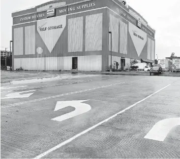  ?? [PHOTO BY JIM BECKEL, THE OKLAHOMAN] ?? Temporary extensions of Oklahoma Avenue from the Oklahoma City Boulevard were recently opened to go around the U-Haul warehouse at 100 SE 2. The city is pursuing eminent domain to acquire the parking east of the warehouse to build a direct connection...