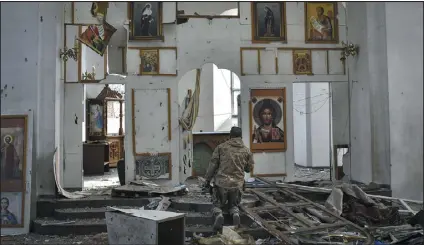  ?? ANDRIY ANDRIYENKO — THE ASSOCIATED PRESS ?? A Ukrainian soldier prays April 5in a church damaged by a Russian air raid in the town of Orikhiv.