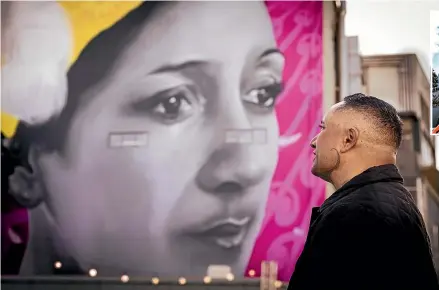  ?? VANESSA LAURIE/STUFF ?? Artist Mr G, Graham Hoete, looks up at his mural of late Māori rights activist Hana Te Hemara on the side of Puke Ariki.